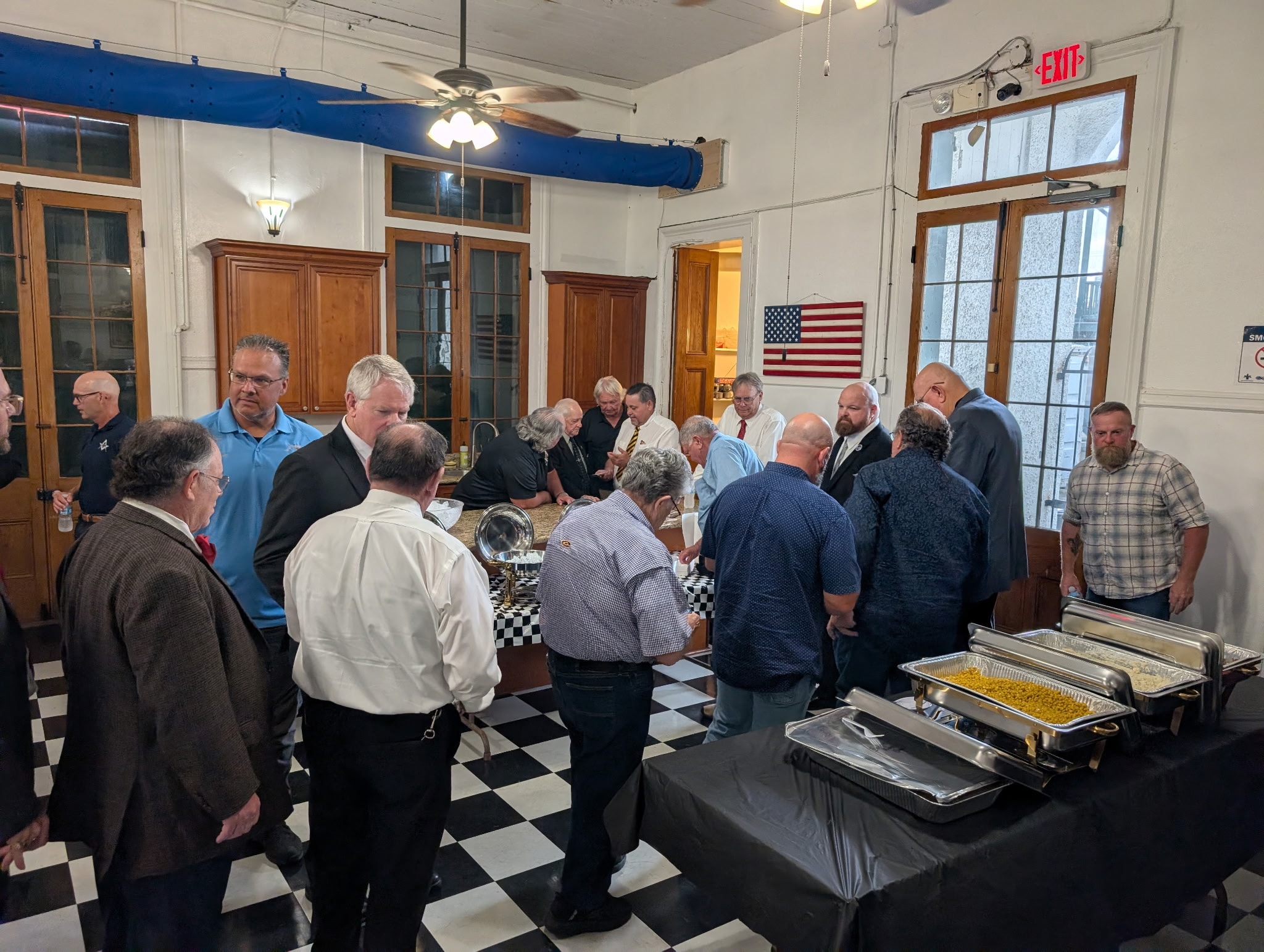 Brothers gathered around the buffet dinner spread in the lodge hall