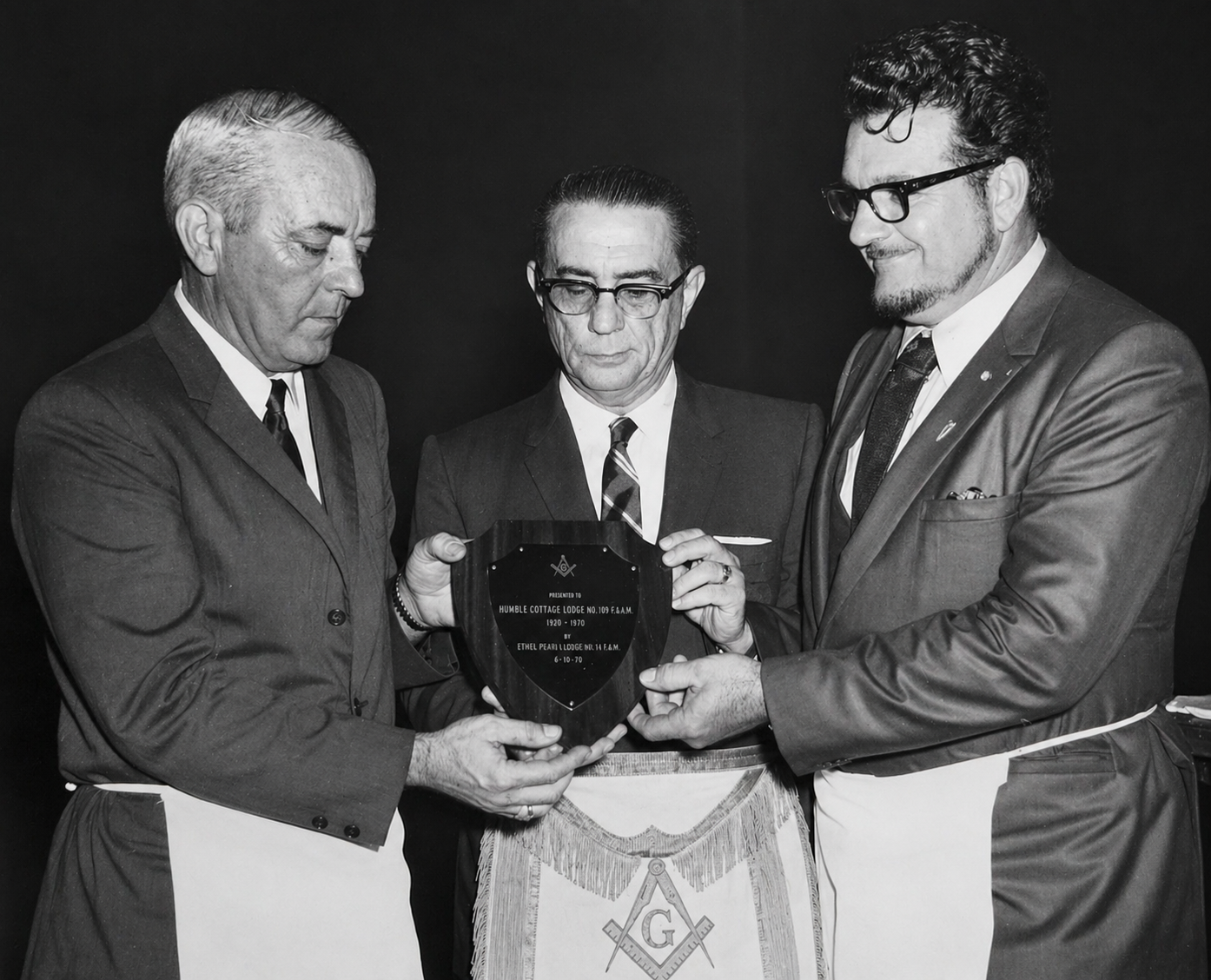 Three brothers presenting a Masonic commemorative plaque, 1970